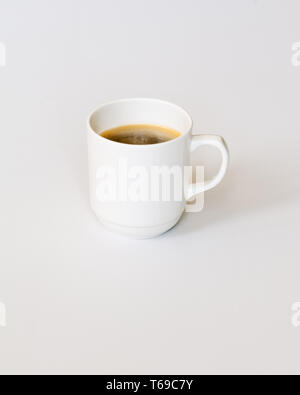 White Cup of Hot Coffee on Gray Background. Stock Photo