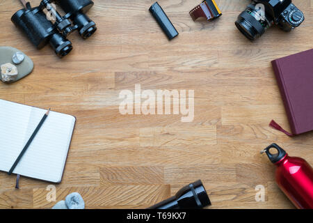Equipment for hiking on a wooden floor background Stock Photo