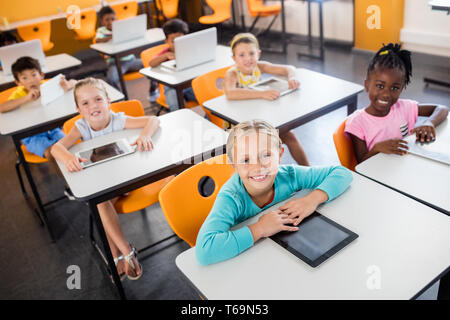 Close up view of pupils studying with laptop and tablet pc Stock Photo