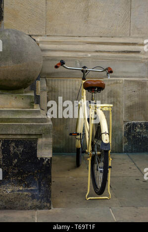 old yellow bicycle. leather seat with shock absorbers and wheel Stock Photo