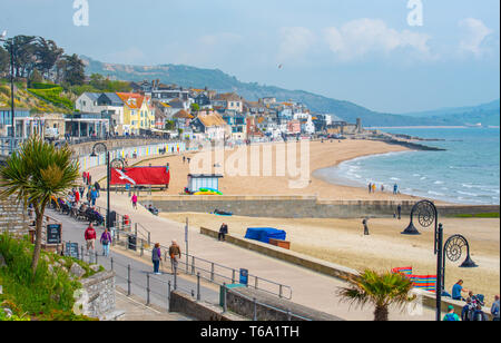 Lyme Regis, Dorset, UK. 30th Apr, 2019. UK Weather: Visitors enjoy warm sunny spells with a light cooling breeze on the beach at Lyme Regis. Cooler conditions are forecast for the forthcoming early May Bank Holiday. Credit: Celia McMahon/Alamy Live News Stock Photo