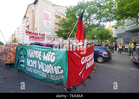 Berlin, Germany. 30th Apr, 2019. Participants of a demonstration walk through the district of Wedding. The demonstration of left-wing groups on the eve of 1 May will be held under the motto 'Hands off Wedding'. The participants want to protest against high rents. Credit: Jörg Carstensen/dpa/Alamy Live News Stock Photo