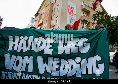 Berlin, Germany. 30th Apr, 2019. Participants of a demonstration walk through the district of Wedding. The demonstration of left-wing groups on the eve of 1 May will be held under the motto 'Hands off Wedding'. The participants want to protest against high rents. Credit: Carsten Koall/dpa/Alamy Live News Stock Photo