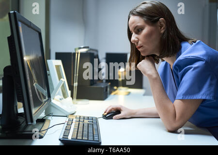 Health Care Female Worker In Hospital With Computer And MRI Stock Photo