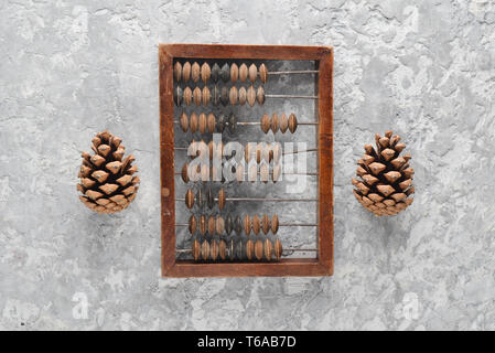 Vintage scores and cones on concrete table. Top view. Ancient methods of counting. Stock Photo