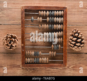 Vintage scores and cones on wooden table. Top view. Ancient methods of counting. Stock Photo