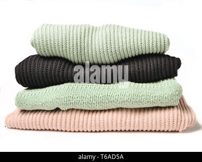 A stack of sweaters isolated on white background. Stock Photo