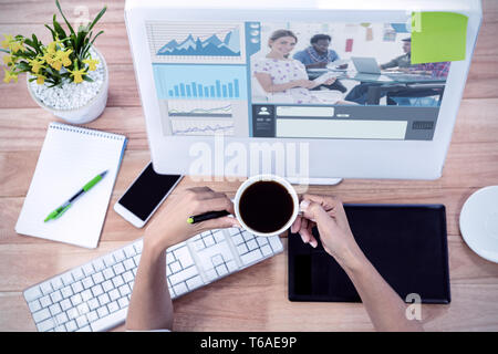 Composite image of editor holding tablet and smiling as team works behind her Stock Photo