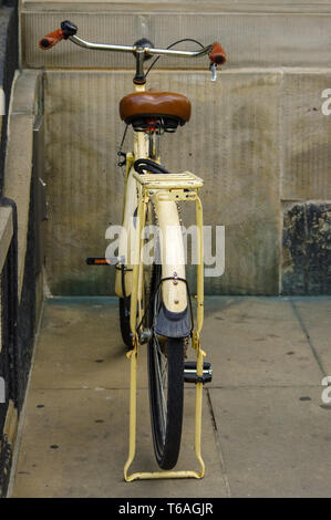 old yellow bicycle. leather seat with shock absorbers and wheel Stock Photo