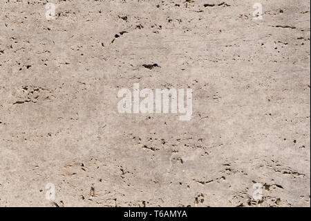 Rough cut Travertine marble or limestone slab with detail in surface needs to be finished off and polished at stone masons Stock Photo