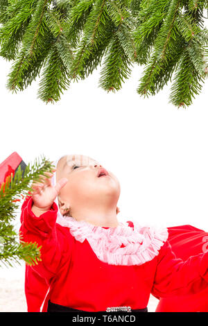 Beautiful baby girl in front of the christmas tree Stock Photo