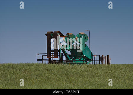 Midland County, Texas  USA - 21 April 2019 : A belt driven pumping unit at a gas well in the Permian Basin oilfield. Stock Photo