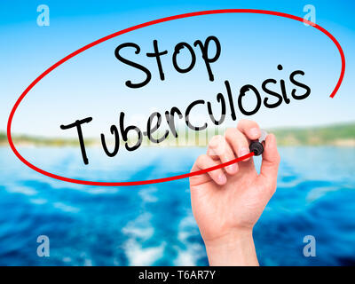 Man Hand writing Stop Tuberculosis with black marker on visual screen. Stock Photo