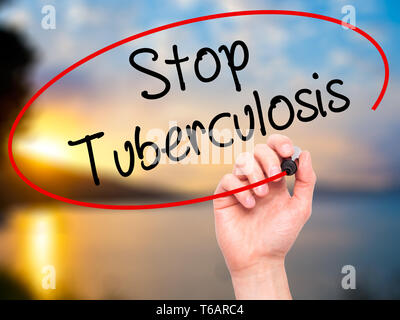 Man Hand writing Stop Tuberculosis with black marker on visual screen. Stock Photo