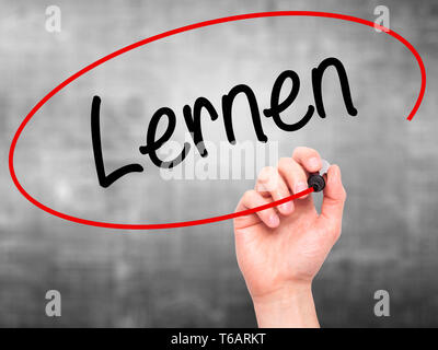 Man Hand writing Lernen (Learn in German) with black marker on visual ...