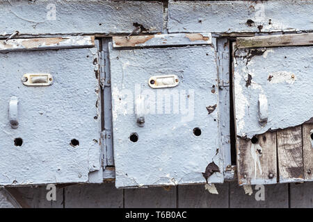 three very old and grungy mailboxes Stock Photo