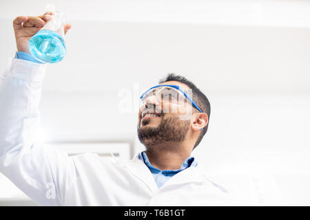 Cheerful chemist satisfied with test solution Stock Photo
