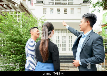 Couple with realtor looking at new house Stock Photo