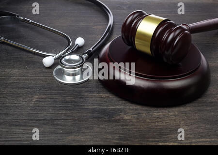 Gavel and stethoscope on black wooden background Stock Photo