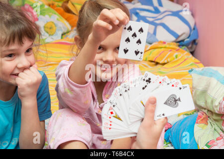 Children happily pull the card from the card fan Stock Photo