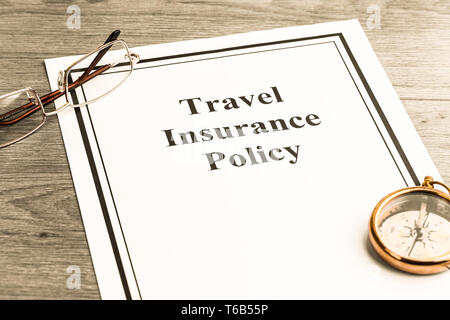 Travel Insurance Policy on Table. Business Concept Stock Photo