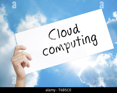Cloud computing Sign on white paper. Man Hand Holding Paper with text. Isolated on sky background Stock Photo