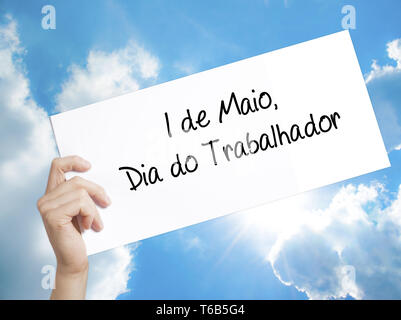 1 de Maio, Dia do Trabalhador (In Portuguese: 1 May, Labor Day)  Sign on white paper. Man Hand Holding Paper with text. Isolated Stock Photo