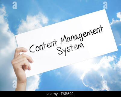 Content Management System  Sign on white paper. Man Hand Holding Paper with text. Isolated on sky background Stock Photo