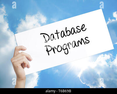Database Programs Sign on white paper. Man Hand Holding Paper with text. Isolated on sky background. Stock Photo