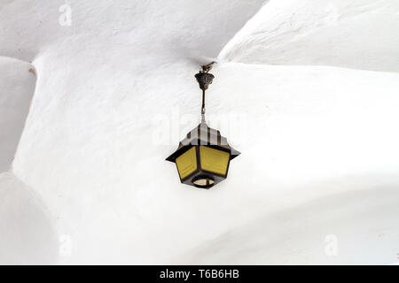 the image of a wrought lantern under the white vault of the castle Stock Photo