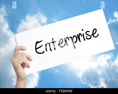 Enterprise Sign on white paper. Man Hand Holding Paper with text. Isolated on sky background Stock Photo