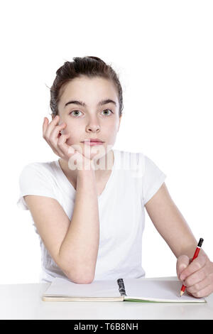 teenage girl is doing her homework Stock Photo