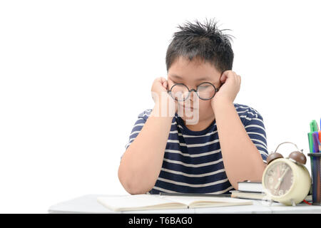 Tired student boy with glasses sleeping on the books isolated on white background, education concept Stock Photo