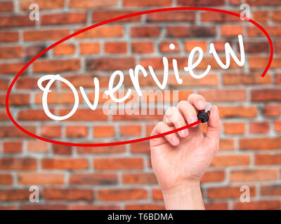 Man Hand writing Overview with black marker on visual screen Stock Photo
