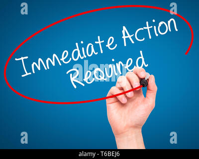Man Hand writing Immediate Action Required with black marker on visual screen Stock Photo