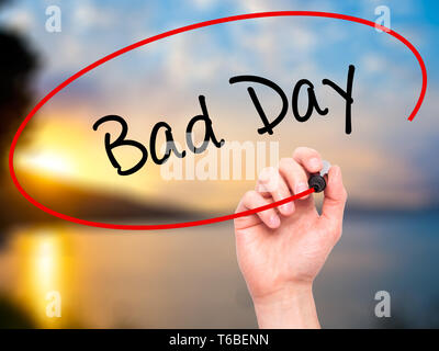 Man Hand writing Bad Day  with black marker on visual screen Stock Photo
