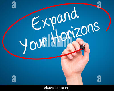 Man Hand writing  Expand Your Horizons  with black marker on visual screen Stock Photo