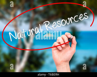 Man Hand writing Natural Resources with black marker on visual screen Stock Photo