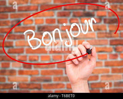 Man Hand writing Bonjour  (Good Morning in French) with black marker on visual screen Stock Photo