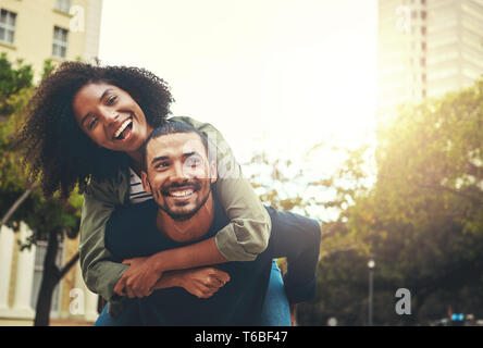 Man giving piggyback ride to woman Stock Photo