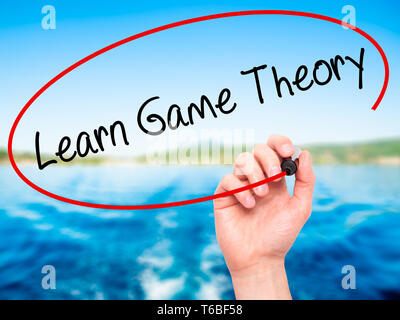 Man Hand writing Learn Game Theory with black marker on visual screen Stock Photo
