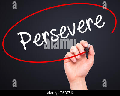 Man Hand writing Persevere with black marker on visual screen. Stock Photo