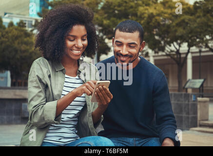 Man looking at his girlfriend using mobile phone Stock Photo