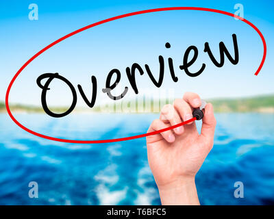 Man Hand writing Overview with black marker on visual screen Stock Photo