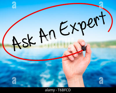 Man Hand writing Ask An Expert with black marker on visual screen Stock Photo