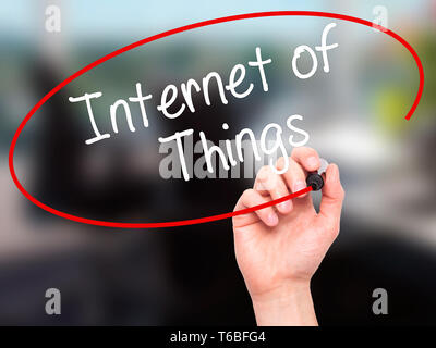 Man Hand writing Internet of Things with black marker on visual screen Stock Photo