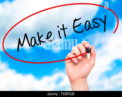Man Hand writing Make it Easy with black marker on visual screen Stock Photo
