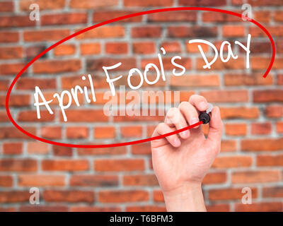 Man Hand writing April Fool's Day with black marker on visual screen Stock Photo