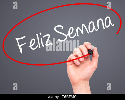 Man Hand writing Feliz Semana  (Happy Week in Spanish/Portuguese) with black marker on visual screen Stock Photo