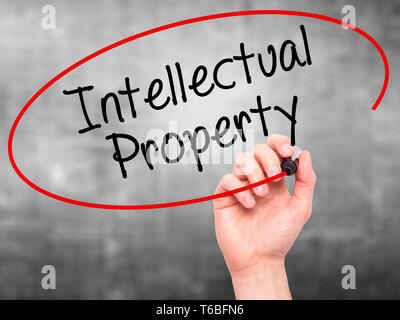 Man Hand writing Intellectual Property with black marker on visual screen Stock Photo